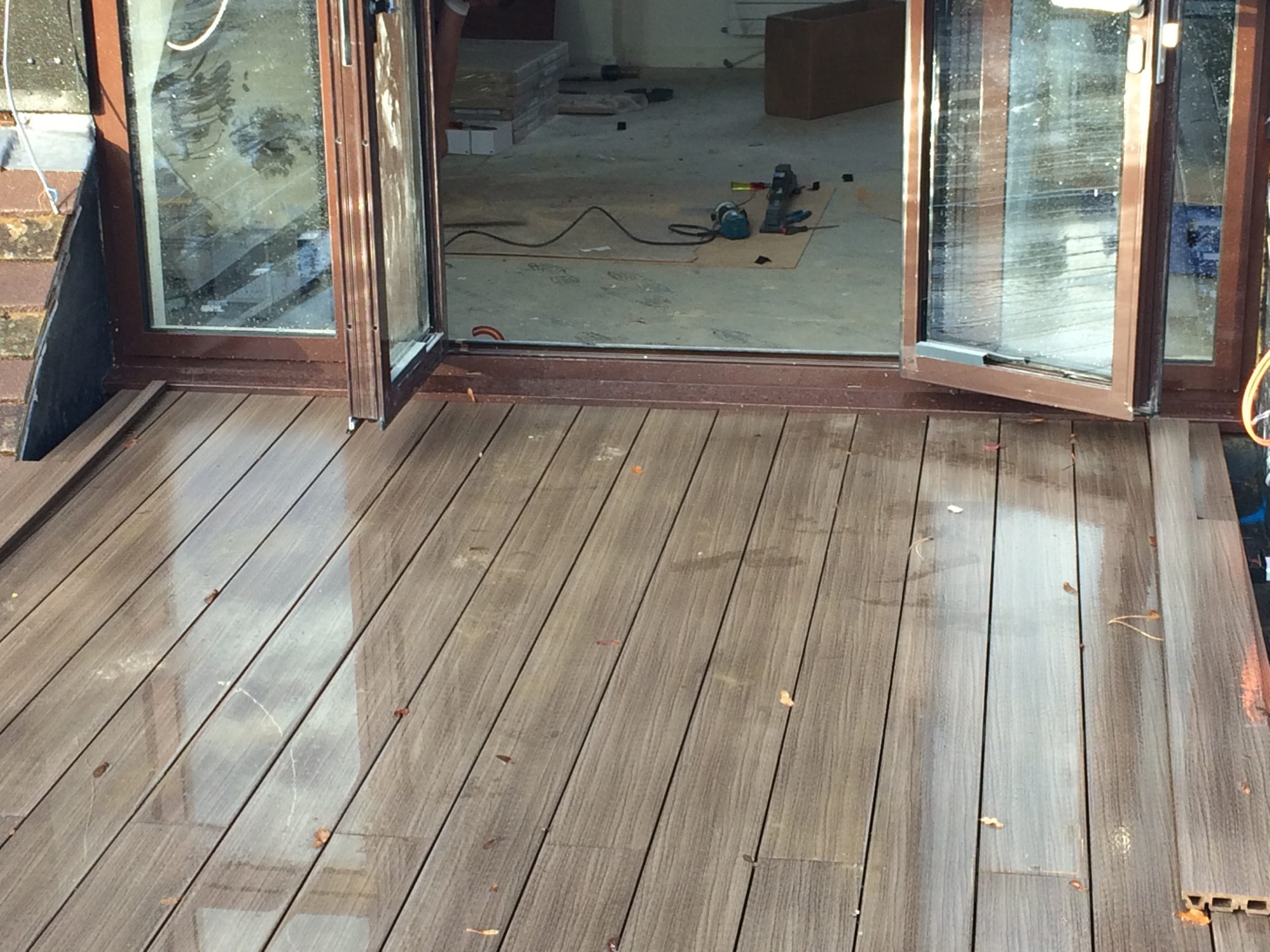 installing Terra composite decking up to doorway 2